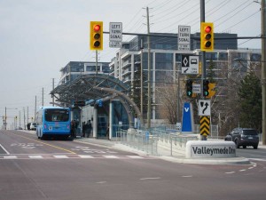 York Region Viva bus at Rapidway stop on Hwy 7, with densification in the background